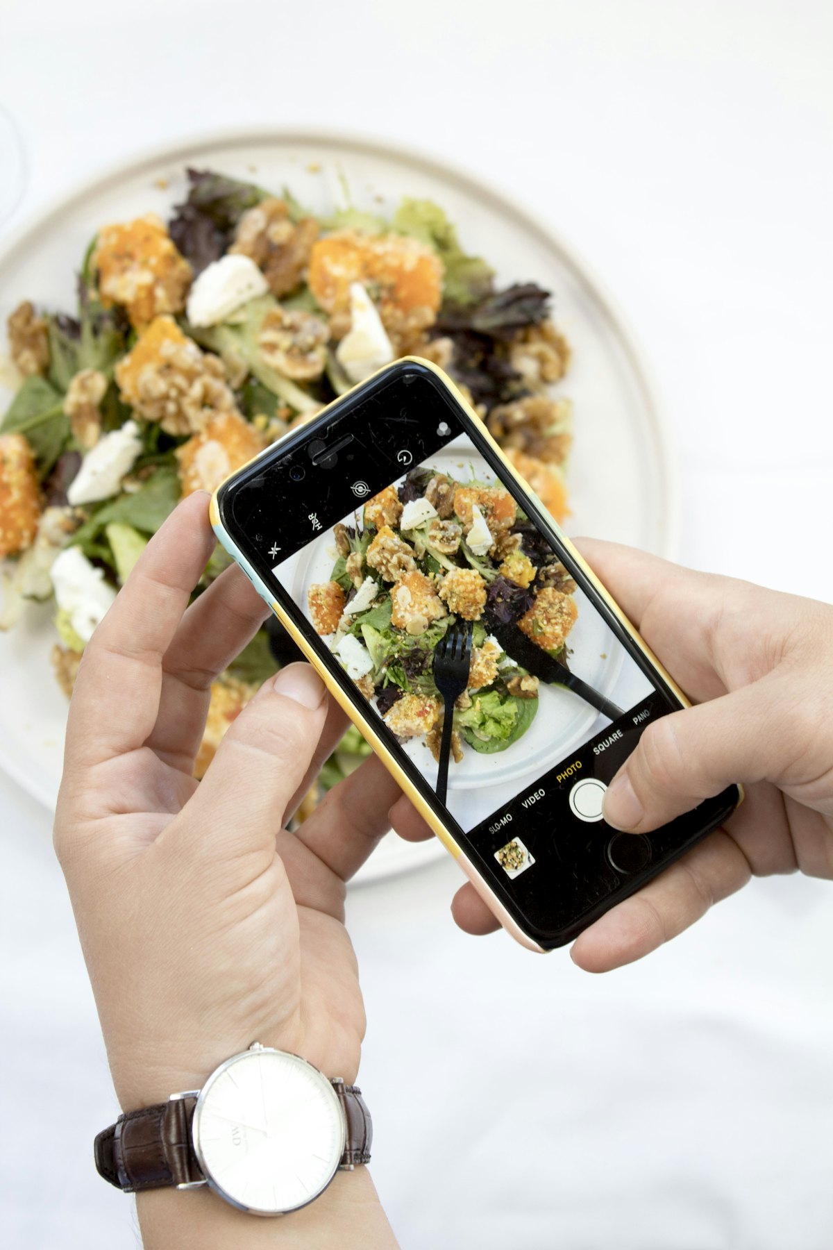 Taking a photo of a salad with a phone